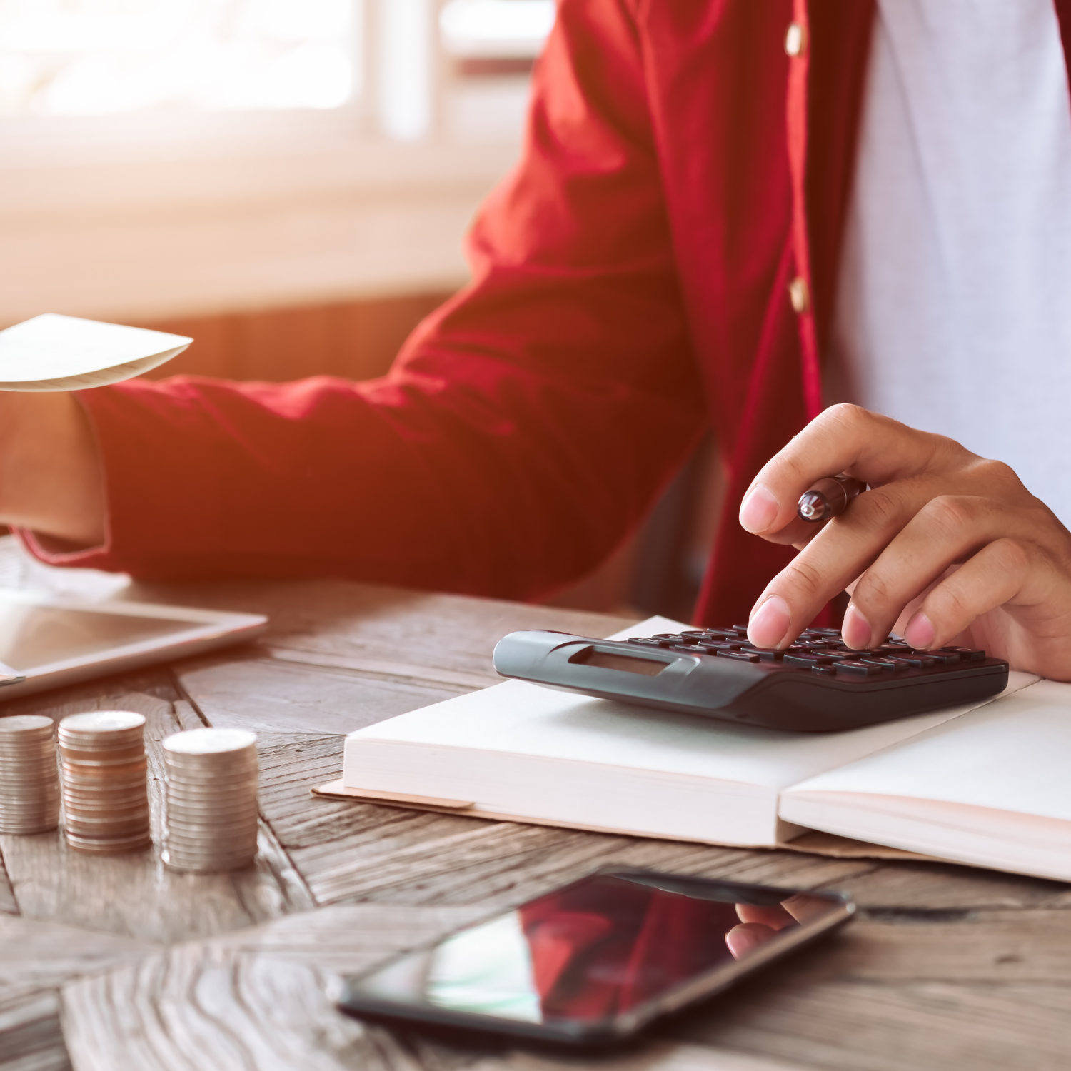 Young professional woman setting financial goals and reviewing her budget at her desk.
