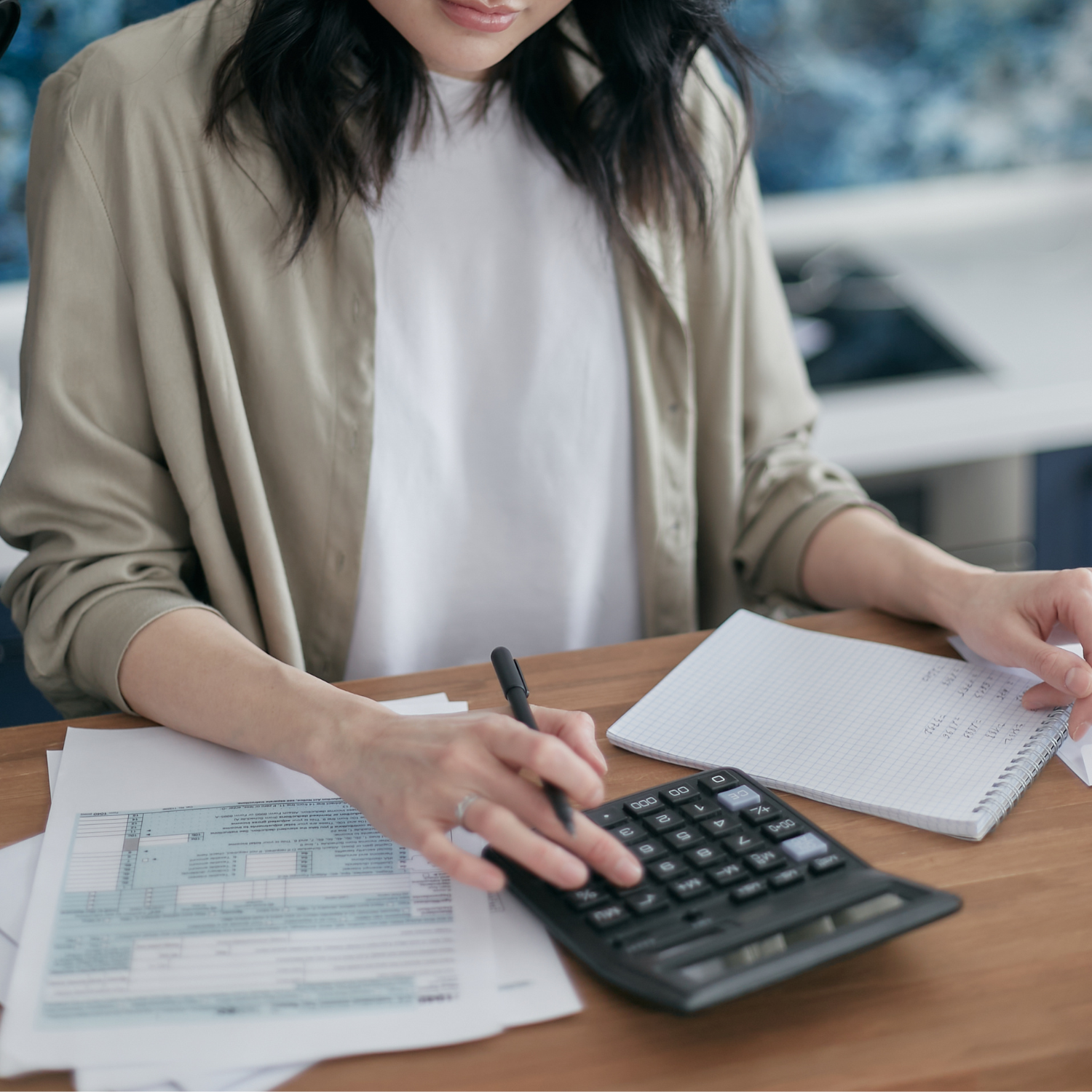 Young professional woman setting financial goals and reviewing her budget at her desk
