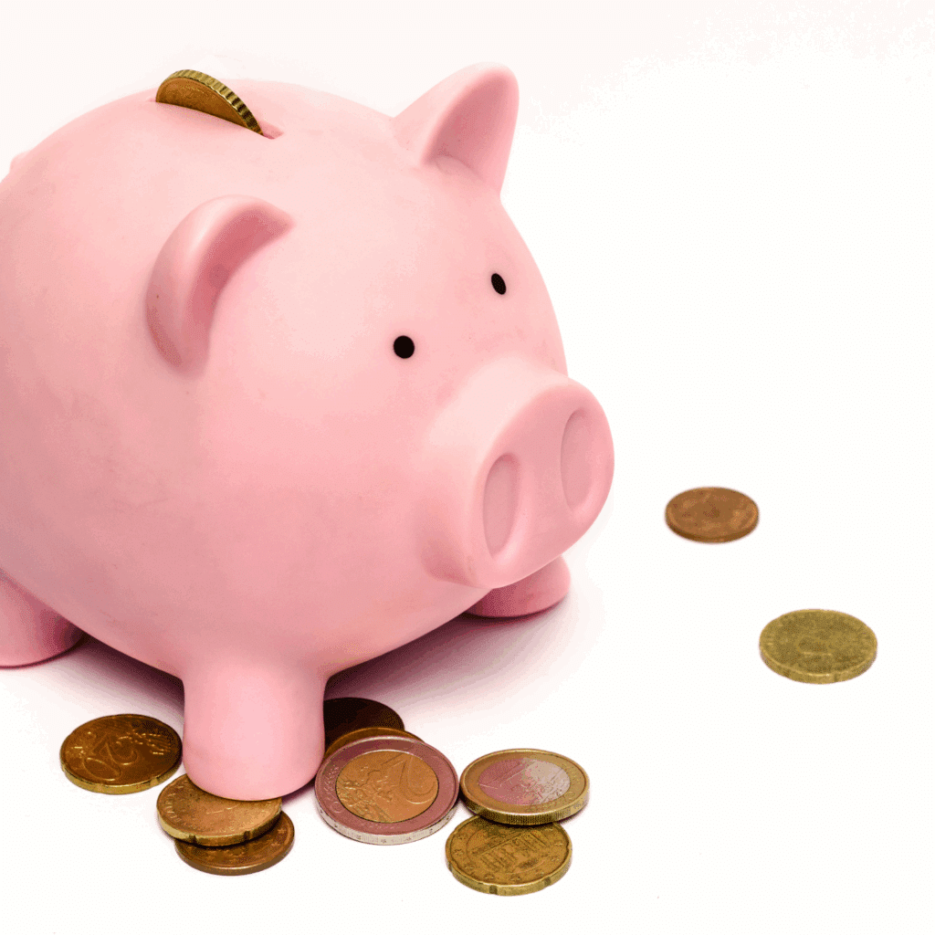 a piggy bank with money spilled