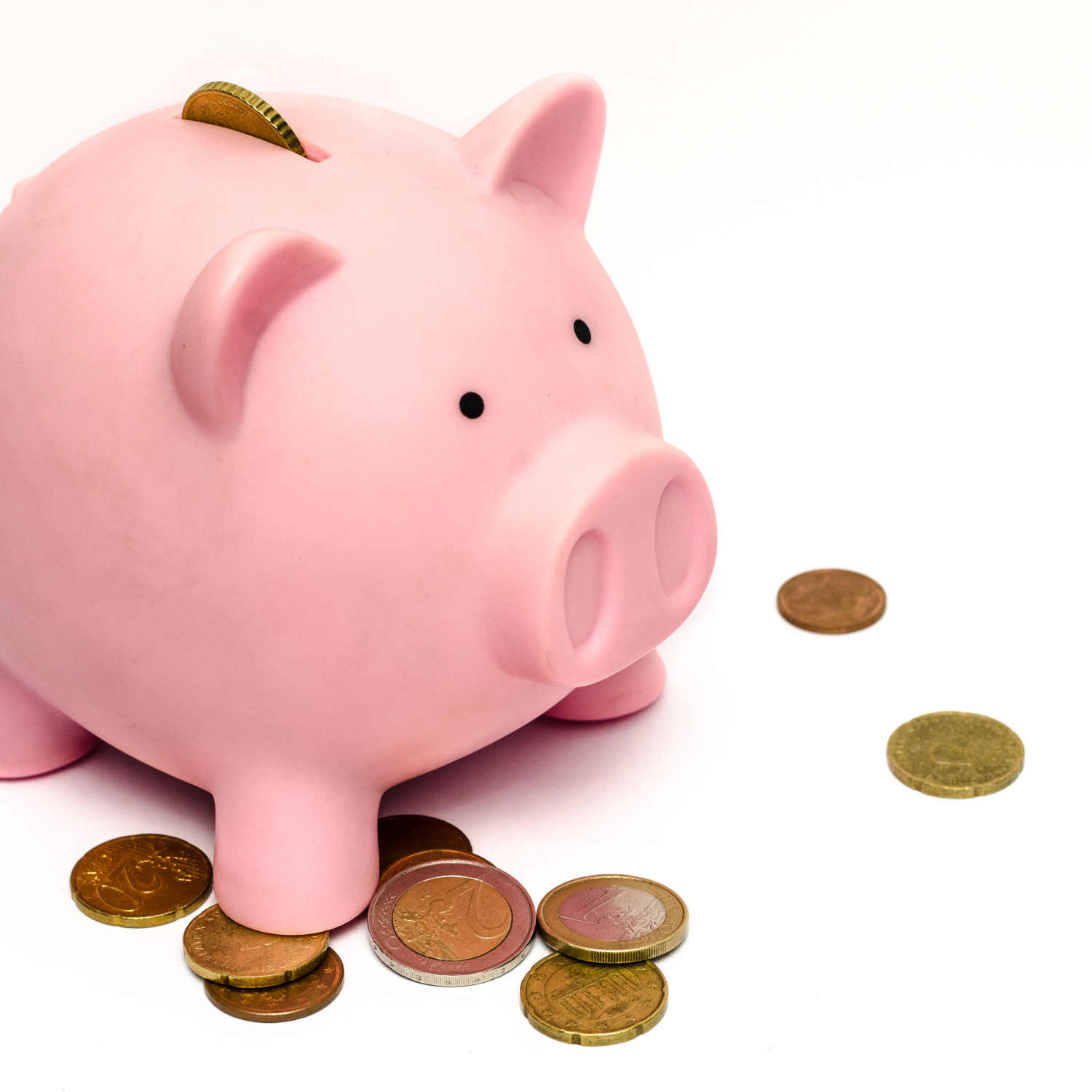 a piggy bank with money spilled